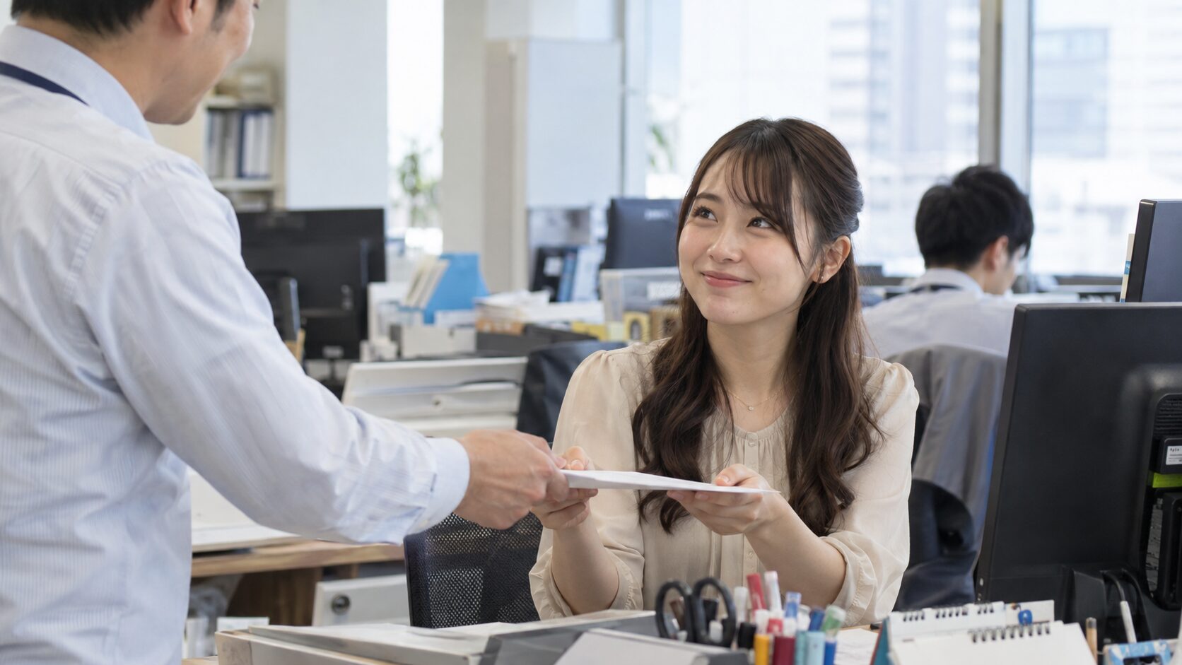職場で同僚から資料を受け取り、笑顔でお礼を伝える女性